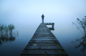 Man standing at the end of a dock