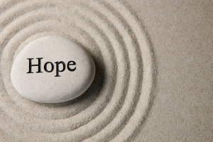 smooth stone with the word "hope" written on it