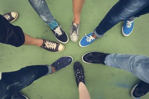 top down view of multicultural huddle with people's shoes